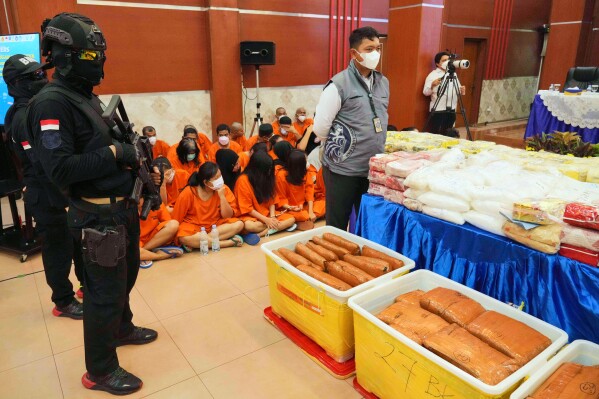 Indonesian police officers stand guard near various drugs seized in a nationwide crackdown in the past few months, before the start of a press conference at the Indonesian Customs headquarters in Jakarta, Indonesia, Monday, June 23, 2025. (AP Photo/Achmad Ibrahim)