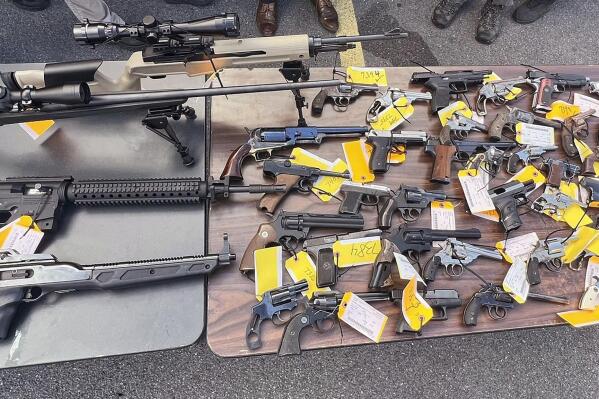 This photo, provided by the Office of New York Attorney General Letitia James, on Aug. 28, 2022 shows some of the 296 firearms, including 177 ghost guns, that were surrendered to law enforcement at a gun buy-back event hosted by her office and the Utica, NY, Police Department. The New York attorney general’s office has tightened rules on gun buybacks after a critic of the policy boasted online about receiving $21,000 in gift cards for weapon parts made on a 3D printer. Buybacks are a popular way for government officials to try to get guns off the streets. But they can also attract people trying to demonstrate that buybacks are futile in the era of printable weapons.  (Office of New York Attorney General via AP)