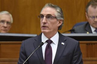 FILE - North Dakota Gov. Doug Burgum delivers his budget address before a joint session of the North Dakota Legislature in Bismarck, N.D., Dec. 5, 2018. Burgum signed a bill Monday, April 24, 2023, that limits access to bathrooms, locker rooms and shower rooms for transgender and gender-nonconforming people in several state facilities. (Tom Stromme/The Bismarck Tribune via AP, File)