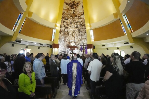 Rev. Angel Andrés González, a Cuban exile, leads Mass at Our Lady of Charity shrine, known as La Ermita, in Miami, Florida, Sunday, Feb. 25, 2024. Though his family was largely non-practicing, González's mother still made him recite Hail Marys during thunderstorms to a print of the Virgin that hung behind his bed since he was baptized in the Cobre sanctuary in Cuba. (AP Photo/Marta Lavandier)