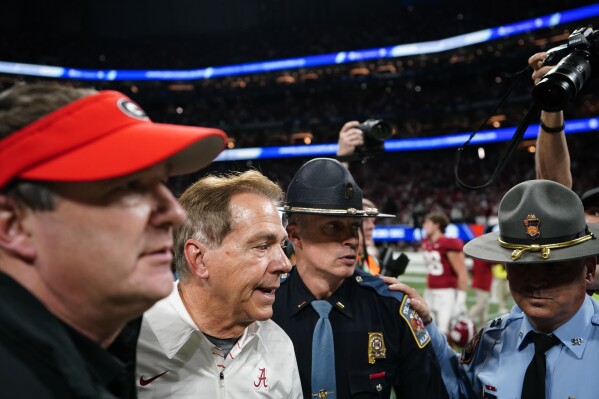 Georgia head coach Kirby Smart, left, and Alabama head coach Nick Saban, right, walk after the Southeastern Conference championship NCAA college football game in Atlanta, Saturday, Dec. 2, 2023. (AP Photo/Brynn Anderson)