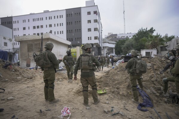 UPDATES INSTRUCTIONS - Israeli soldiers stand outside Shifa Hospital in Gaza City, Wednesday, Nov. 22, 2023. Israel says that Hamas militants sought cover on the grounds of the hospital and used the tunnel for military purposes. (AP Photo/Victor R. Caivano)