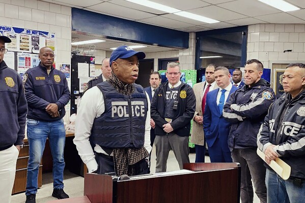 FILE - This photo provided by the Office of New York City Police Department Assistant Commissioner Kaz Daughtry, Monday, Feb. 5, 2024, shows New York Mayor Eric Adams, left center, who joined investigators and specialized teams as they carried out a search warrant. (Office of New York City Police Department Assistant Commissioner Kaz Daughtry via AP, File)