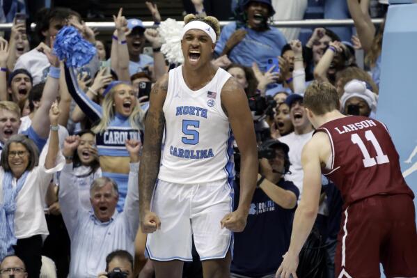 North Carolina forward Armando Bacot (5) and fans celebrate after he slam-dunked over College of Charleston guard Ryan Larson (11) during the second half of an NCAA college basketball game Friday, Nov. 11, 2022, in Chapel Hill, N.C. (AP Photo/Chris Seward)