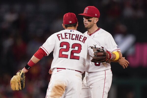 Los Angeles Angels second baseman David Fletcher, left, celebrates with shortstop Zach Neto after the team's win against the Oakland Athletics in a baseball game Friday, Sept. 29, 2023, in Anaheim, Calif. (AP Photo/Ryan Sun)