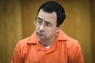 
              FILE - In this Feb. 2, 2018, file photo, Larry Nassar listens as Melissa Alexander Vigogne gives her victim statement in Eaton County Circuit Court in Charlotte, Mich.  Fifty-one women are suing the U.S. Olympic Committee, its board members and a number of former high-ranking officials for failing to prevent their abuse at the hands of imprisoned sports doctor Larry Nassar. The lawsuit, filed Tuesday, March 12, 2019, in federal court in Denver, details abuse dating to the late 1990s.  (Matthew Dae Smith/Lansing State Journal via AP, File)
            