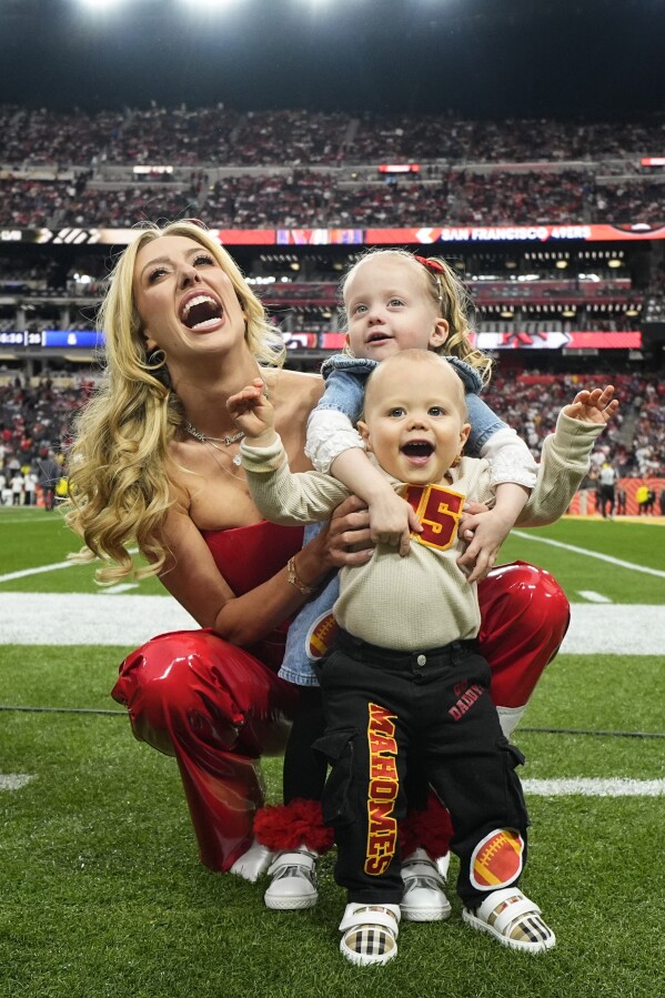 Brittany Mahomes poses for a photo with her children Sterling and Bronze before the NFL Super Bowl 58 football game between the San Francisco 49ers and the Kansas City Chiefs, Sunday, Feb. 11, 2024, in Las Vegas. (AP Photo/Julio Cortez)