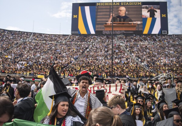 Rawan Antar, 21, center, chants in support of Palestinians during the University of Michigan's Spring 2024 Commencement Ceremony at Michigan Stadium in Ann Arbor, Mich., on Saturday, May 4, 2024. (Katy Kildee/Detroit News via AP)