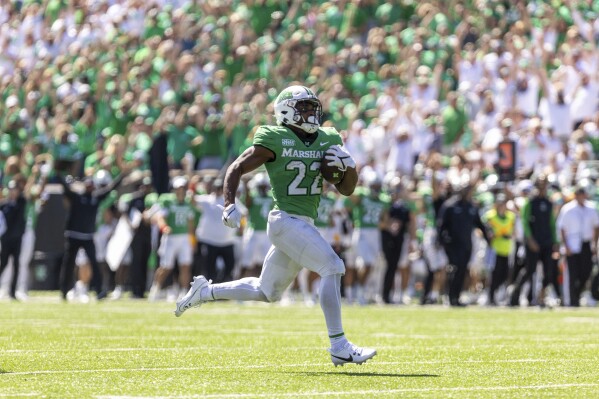 Marshall running back Rasheen Ali (22) breaks free for a score as the Herd takes on Virginia Tech during an NCAA college football game, Saturday, Sept. 23, 2023, at Joan C. Edwards Stadium in Huntington, W.Va. (Sholten Singer/The Herald-Dispatch via AP)