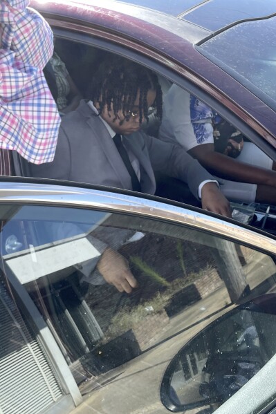 D'Monterrio Gibson, seated, leaves the Lincoln County Courthouse in Brookhaven, Miss., on Thursday, Aug. 17, 2023, after a judge declared a mistrial for Gregory Case and Brandon Case, two white men who are charged in a 2022 attack on Gibson. Prosecutors said the attack happened after Gibson delivered a package for FedEx, and a new trial will be set for the two men who are father and son. (AP Photo/Emily Wagster Pettus)