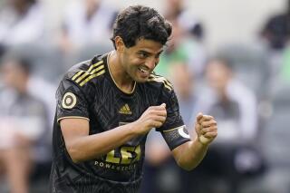 FILE - Los Angeles FC's Carlos Vela reacts after missing a shot during the second half of an MLS soccer match against the Colorado Rapids on Feb. 26, 2022, in Los Angeles. Vela re-signed with Los Angeles FC on Tuesday, June 28, 2022, extending his tenure with the Major League Soccer leaders through the 2023 season. (AP Photo/Jae C. Hong, File)