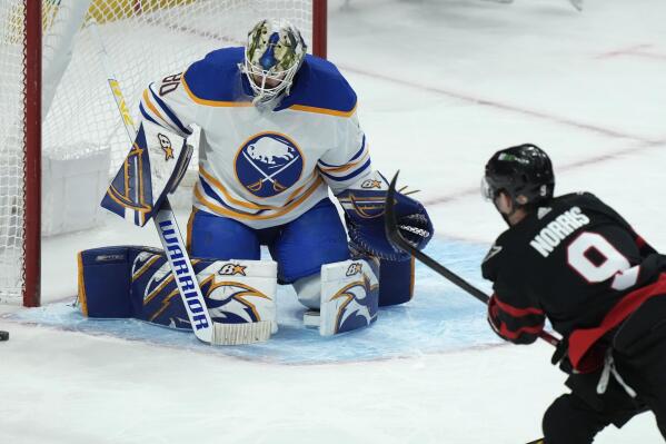 Buffalo Sabres goaltender Aaron Dell guards the net as Ottawa Senators centre Josh Norris fires the puck wide during the first period of an NHL hockey game, Tuesday, Jan. 25, 2022, in Ottawa, Ontario. (Adrian Wyld/The Canadian Press via AP)
