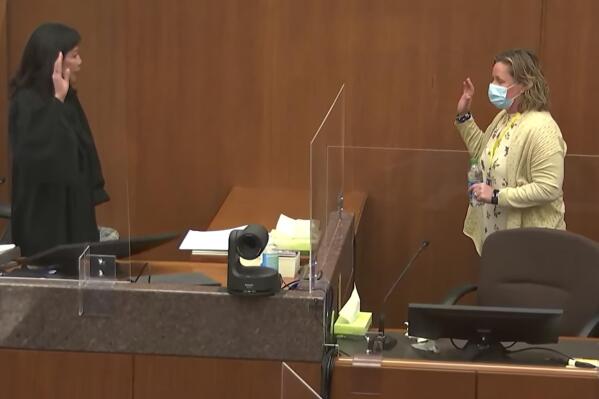 In this screen grab from video, Hennepin County Judge Regina Chu left, swears in former Brooklyn Center Police Officer Kim Potter before she testifies in court Friday, Dec. 17, 2021 at the Hennepin County Courthouse in Minneapolis, Minn.   Potter is charged with first and second-degree manslaughter in the April 11 shooting of Daunte Wright, a 20-year-old Black motorist, following a traffic stop in the Minneapolis suburb of Brooklyn Center.(Court TV, via AP, Pool).