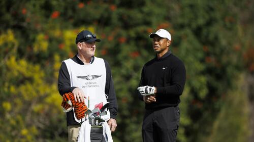 FILE - Tiger Woods talks with caddie Joe LaCava on the fourth tee during the second round of the Genesis Invitational golf tournament at Riviera Country Club, Friday, Feb. 17, 2023, in the Pacific Palisades area of Los Angeles. Woods won't be at the Wells Fargo Championship, but his caddie will be. Or rather, his former caddie. Joe LaCava, who was on the bag for Woods since 2011 and helped him win his fifth Masters in 2019, has moved on to caddie for Patrick Cantlay for the remainder of the season.(AP Photo/Ryan Kang, File)