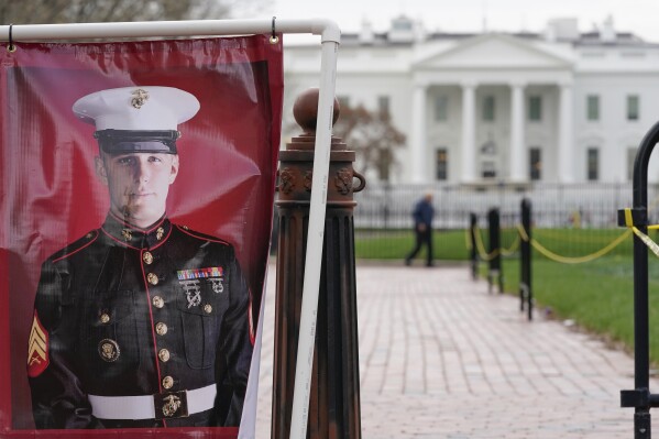 FILE - A poster photo of U.S. Marine Corps veteran and former Russian prisoner Trevor Reed stands in Lafayette Park near the White House, March 30, 2022, in Washington. Reed, a former U.S. Marine who was released from Russia in a prisoner swap last year, has been injured while fighting in Ukraine, the State Department and a person familiar with the matter said Tuesday. (AP Photo/Patrick Semansky, File)