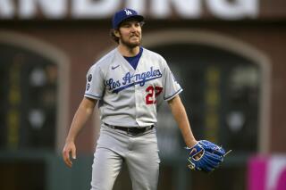 FILE - Los Angeles Dodgers starting pitcher Trevor Bauer reacts to a pitch call during the fourth inning of the team's baseball game against the San Francisco Giants, Friday, May 21, 2021, in San Francisco. Dodgers pitcher Trevor Bauer's administrative leave was extended yet again, this time by six additional days through April 22, 2022, by Major League Baseball and the players’ association. The decision was made Wednesday, April 13, a person familiar with the proceedings said, speaking on condition of anonymity because no announcement was authorized. (AP Photo/D. Ross Cameron, File)