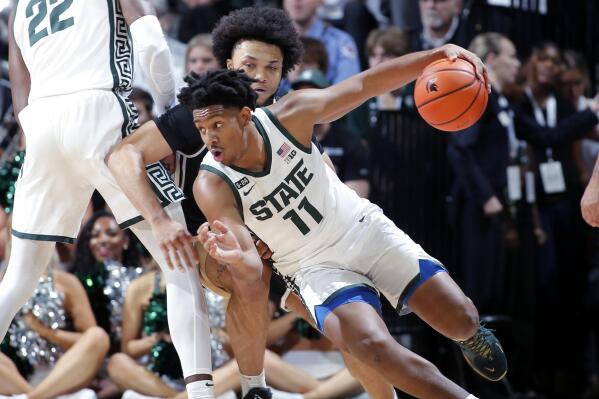 Michigan State's A.J. Hoggard (11) drives against Brown's Dan Friday during the first half of an NCAA college basketball game, Saturday, Dec. 10, 2022, in East Lansing, Mich. (AP Photo/Al Goldis)
