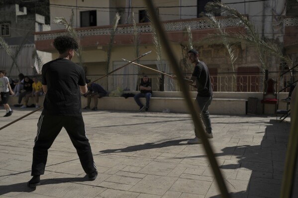 Members of the Maronite Church of St. George rehearse for the traditional Good Friday procession in Quraye, near the southern port city of Sidon, Lebanon, Thursday, April 17, 2025. (AP Photo/Hassan Ammar)