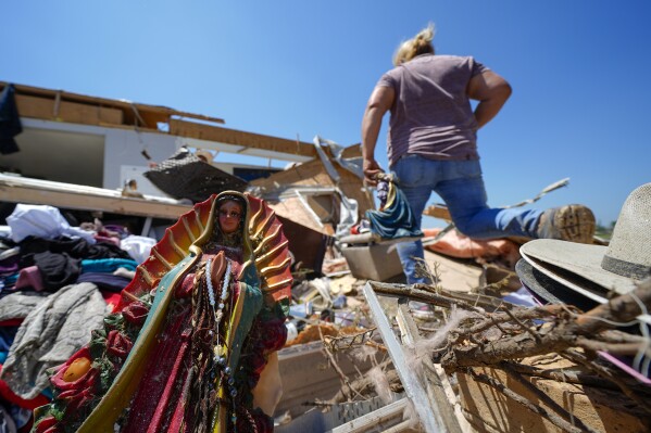 A Guadalupe Virgin statue lays among the rubble of the destroyed home of Juana Landeros, who rode out a deadly tornado with her husband and her 9-year-old son when it rolled through the previous night, Sunday, May 26, 2024, in Valley View, Texas. Powerful storms left a wide trail of destruction Sunday across Texas, Oklahoma and Arkansas after obliterating homes and destroying a truck stop where drivers took shelter during the latest deadly weather to strike the central U.S. (AP Photo/Julio Cortez)