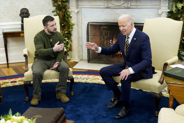FILE - President Joe Biden speaks with Ukrainian President Volodymyr Zelenskyy as they meet in the Oval Office of the White House, Dec. 21, 2022, in Washington. Zelenskyy arrives in Washington for a whirlwind return visit, this time to face the Republicans now questioning the flow of American dollars that has kept his troops in the fight against Russian forces. (AP Photo/Patrick Semansky, File)