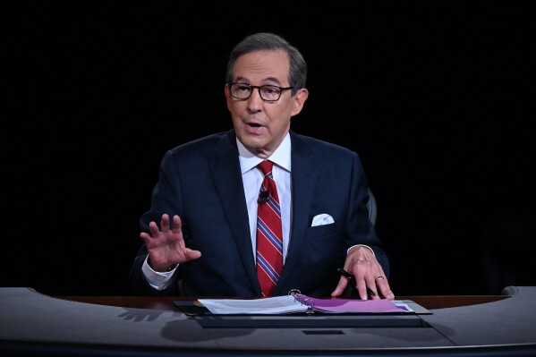 FILE - Moderator Chris Wallace speaks as President Donald Trump and Democratic presidential candidate former Vice President Joe Biden participate in the first presidential debate in Cleveland on Sept. 29, 2020. Wallace has written a book on the race between John F. Kennedy and Richard Nixon. The race was narrowly won by Kennedy and featured the first televised presidential debates. Dutton announced Wednesday that “Countdown 1960: The Behind-the-Scenes Story of the 311 Days that Changed America’s Politics Forever” will be published Oct. 8. (Olivier Douliery/Pool via AP, File)