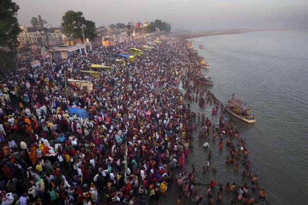 Thousands of Hindu devotees take a holy dip on the occasion of Ramnavi festival, celebrated as the birthday of Hindu God Rama, in Ayodhya, India, Thursday, March 30, 2023. India is on track to become the world's most populous nation, surpassing China by 2.9 million people by mid-2023, according to data released by the United Nations on Wednesday. The South Asian country will have an estimated 1.4286 billion people against China's 1.4257 billion by the middle of the year, according to U.N. projections.(AP Photo/Manish Swarup)