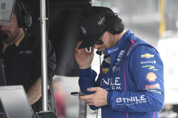 Conor Daly looks at his phone during practice for the Indianapolis 500 auto race at Indianapolis Motor Speedway, Friday, May 19, 2023, in Indianapolis. (AP Photo/Darron Cummings)