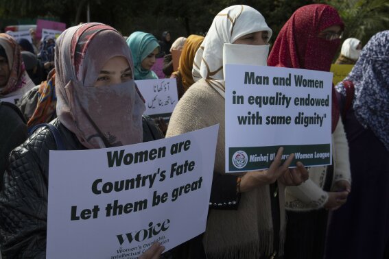 FILE - In this March 8, 2020 file photo Activists of the Pakistani religious party Minhaj-ul-Quran observe International Women's Day at a rally in Islamabad, Pakistan. An annual human rights report released this week gives Pakistan a failing grade, charging that too little is being done to protect the country's most vulnerable, including women and children. (AP Photo/B.K. Bangash, File)