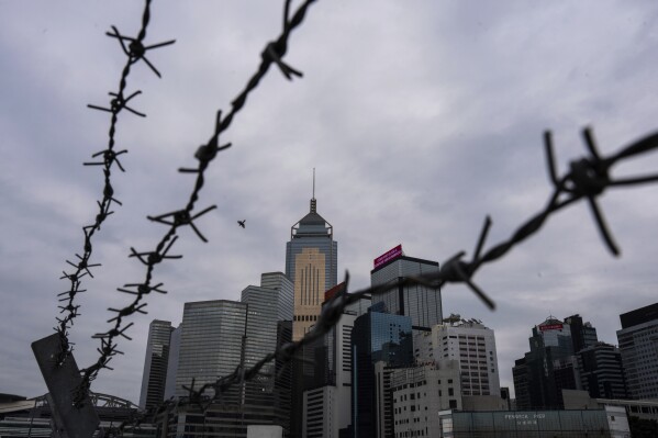 FILE - Cityscape is seen in Hong Kong on March 19, 2024. Hong Kong's leader said Tuesday, March 26, that prisoners convicted for serious national security crimes would not likely be granted early release under the tightened rules of a new national security law, signaling a hardening government stance against jailed political activists. (AP Photo/Louise Delmotte, File)