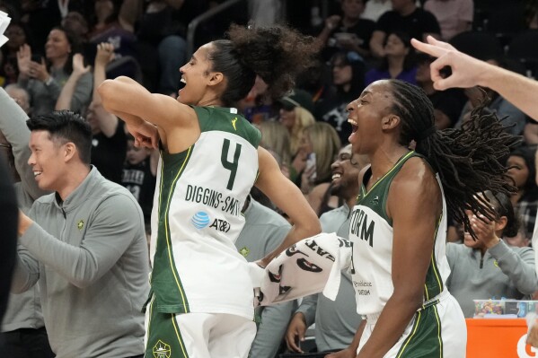 Seattle Storm guard Skylar Diggins-Smith (4) and Storm forward Nneka Ogwumike celebrate a made 3-pointer against the Phoenix Mercury during the second half of a WNBA basketball game, Sept. 19, 2024, in Phoenix. (AP Photo/Ross D. Franklin, file)