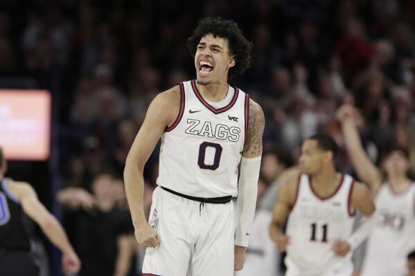 Gonzaga guard Julian Strawther (0) celebrates his basket during the second half of the team's NCAA college basketball game against BYU, Saturday, Feb. 11, 2023, in Spokane, Wash. Gonzaga won 88-81. (AP Photo/Young Kwak)
