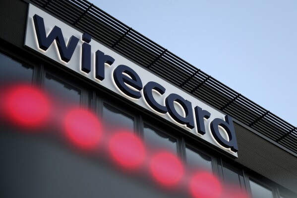 FILE - The logo of payment company Wirecard is pictured at the headquarters in Munich, Germany on July 20, 2020. Austria faces its biggest espionage scandal in decades as the arrest of a former intelligence officer brings to light evidence of extensive Russian infiltration, lax official oversight and behavior worthy of a spy novel. (AP Photo/Matthias Schrader, File)