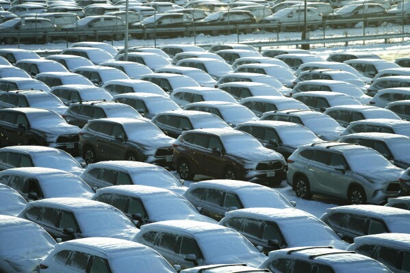 Snow-covered vehicles sit in a rental car parking lot at Chicago's O'Hare International Airport on Sunday, Jan. 14, 2024.  A wind chill warning is in effect as dangerously cold conditions continue in the Chicago area.  (AP Photo/Nam Y. Huh)