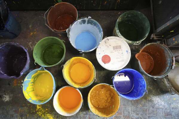 Buckets of paint used for stage canvases are seen in a laboratory of the "Teatro dell' Opera" opera house warehouse, in Rome, Thursday, April 10, 2025. (AP Photo/Andrew Medichini)