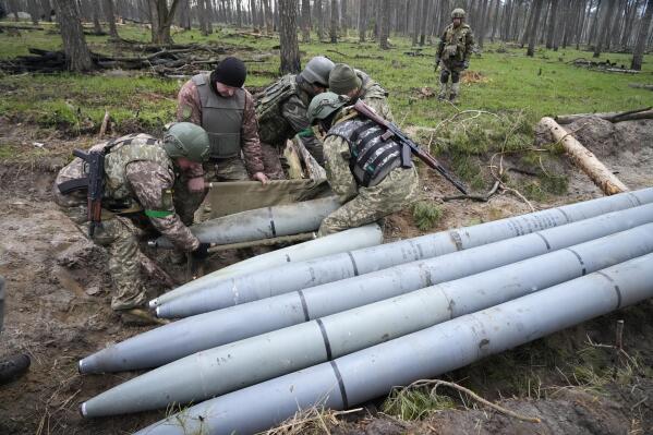 FILE - Ukrainian soldiers collect multiple Russian 'Uragan' missiles after recent fights in the village of Berezivka, Ukraine, April 21, 2022. A majority of U.S. adults say misinformation around Russia’s invasion of Ukraine is a major problem, and they largely fault the Russian government for spreading those falsehoods. A new poll from The Associated Press-NORC Center for Public Affairs Research shows 61% of Americans say the spread of misinformation about the war is a major problem, with only 7% saying it's not a problem. (AP Photo/Efrem Lukatsky, File)