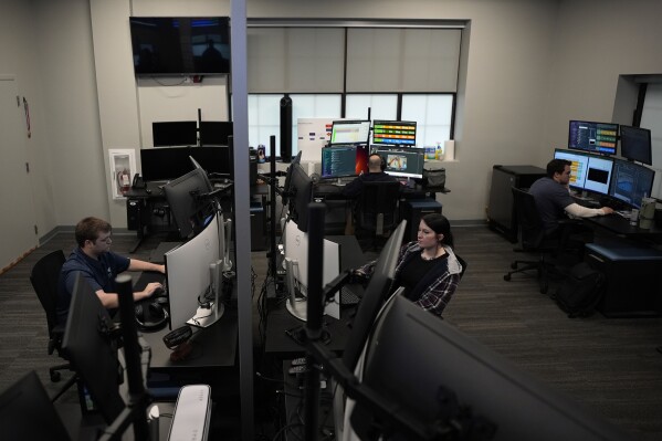 ZeroEyes analysts monitor alerts at the company's operations center, Friday, May 10, 2024, in Conshohocken, Pa. (AP Photo/Matt Slocum)