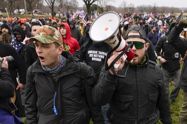FILE - Proud Boys members Zachary Rehl, left, and Ethan Nordean, walk toward the U.S. Capitol in Washington, in support of President Donald Trump, Jan. 6, 2021. Federal prosecutors disclosed Wednesday, March 22, 2023, that a witness expected to testify for the defense at the seditious conspiracy trial of former Proud Boys leader Enrique Tarrio and four associates was secretly acting as a government informant. (AP Photo/Carolyn Kaster, File)
