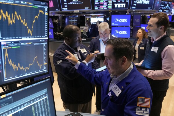 Wall Street surges to records as Fed signals rate cuts