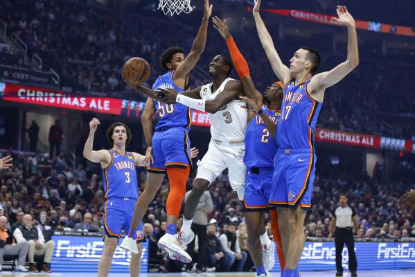 Cleveland Cavaliers guard Caris LeVert (3) shoots against Oklahoma City Thunder forward Jeremiah Robinson-Earl (50), guard Shai Gilgeous-Alexander (2) and forward Aleksej Pokusevski (17) during the first half of an NBA basketball game, Saturday, Dec. 10, 2022, in Cleveland. (AP Photo/Ron Schwane)