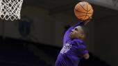 Hansel Enmanuel, a freshman guard from the Dominican Republic for Northwestern State, practices dunks during warm-ups before an NCAA college basketball game against Rice Saturday, Dec. 17, 2022, in Houston. Enmanuel lost his left arm in a childhood accident and has attained the talent and skill to play at the college level. (AP Photo/Michael Wyke)