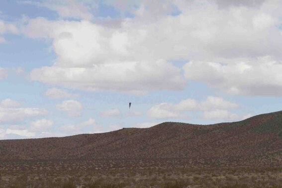 In this Saturday afternoon, Feb. 22, 2020, photo "Mad" Mike Hughes rocket plunges back to earth near Barstow, Calif. A California man who said he wanted to fly to the edge of outer space to see if the world is flat or round has died after his home-built rocket blasted off into the desert sky and plunged back to earth. "Mad" Mike Hughes, 64, was killed on Saturday after his rocket crashed. (Mercedes Blackehart via AP)