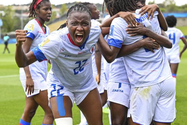 Roselord Borgella of Haiti celebrates a goal by teammate Melchie Dumonay during their FIFA women's World Cup qualifier against Chile in Auckland, New Zealand, Wednesday, Feb. 22, 2023. (Andrew Cornaga/Photosport via AP)