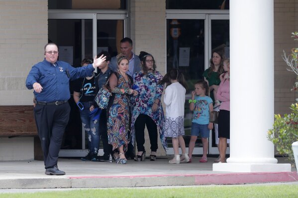 Congregants exit after services at the Life Tabernacle Church in Central, La., Sunday, March 29, 2020. Pastor Tony Spell has defied a shelter-in-place order by Louisiana Gov. John Bel Edwards, due to the new coronavirus pandemic, and continues to hold church services with hundreds of congregants. (AP Photo/Gerald Herbert)