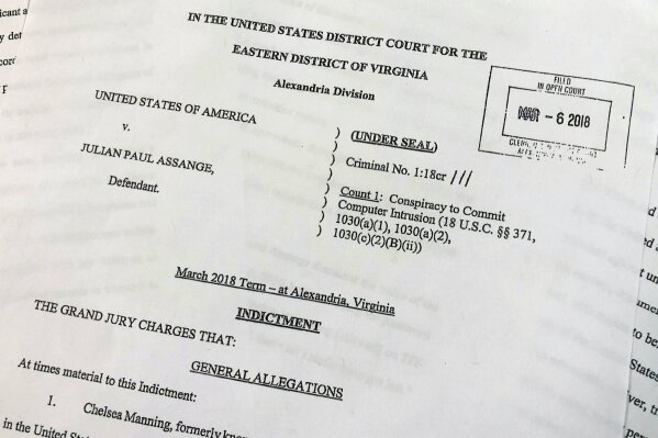 
              The Grand Jury Indictment against Julian Assange, released by the U.S. Department of Justice, Thursday, April 11, 2019, is photographed in Washington.  The U.S. Justice Department has charged WikiLeaks founder Julian Assange with conspiring with Chelsea Manning to break into a classified government computer. (AP Photo/Wayne Partlow)
            