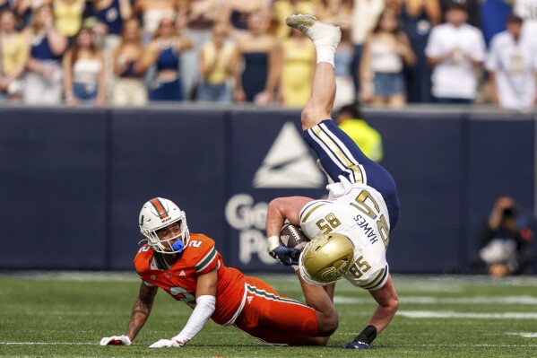 Georgia Tech tight end Jackson Hawes (85) is tackled by Miami defensive back Daryl Porter Jr. (2) during the first half of an NCAA college football game, Saturday, Nov. 9, 2024, in Atlanta. (AP Photo/Jason Allen)