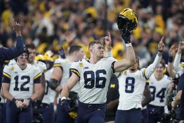 Michigan tight end Luke Schoonmaker (86) celebrates with teammates at the end of the Big Ten championship NCAA college football game against Iowa, Saturday, Dec. 4, 2021, in Indianapolis. Michigan won 42-3. (AP Photo/Darron Cummings)