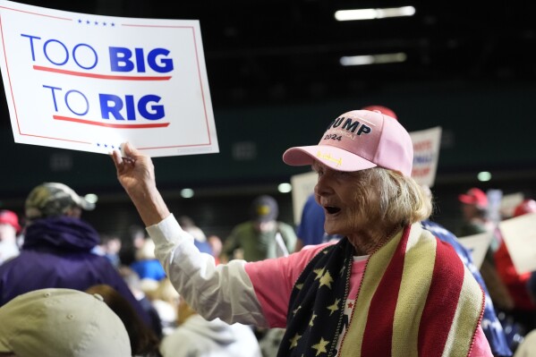 Supporters wave signs before Republican presidential candidate former President Donald Trump speaks at a campaign rally Saturday, March 2, 2024, in Greensboro, N.C. (AP Photo/Chris Carlson)