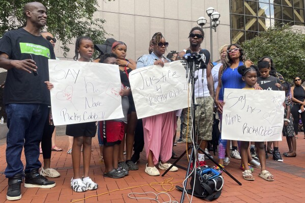 Family members of Ricky Cobb II, a Black man who was shot and killed by a Minnesota State Patrol trooper, speak at a news conference outside Hennepin County Government Center in Minneapolis on Wednesday, Aug. 2, 2023. They joined members of activist groups in demanding that Minnesota's Democratic Gov. Tim Walz fire the three officers who were involved in stopping Cobb on a Minneapolis freeway on Monday, July 31, which led to Cobb's death. (AP Photo/Trisha Ahmed)