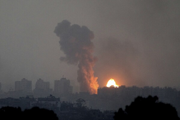 Fire and smoke rise following an Israeli airstrike in the Gaza Strip, as seen from southern Israel, Saturday, Oct. 28, 2023. (AP Photo/Ilan Assayag)