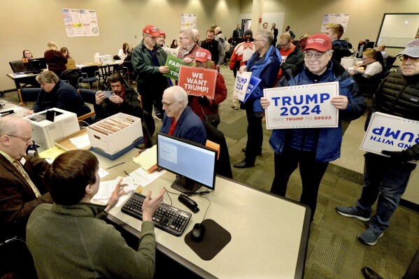 Supporters of Republican presidential candidate Donald Trump submit nomination papers with state election authorities, Thursday, Jan. 4, 2024, at the State Board of Elections in Springfield, Ill. (Thomas J. Turney/The State Journal-Register via AP)